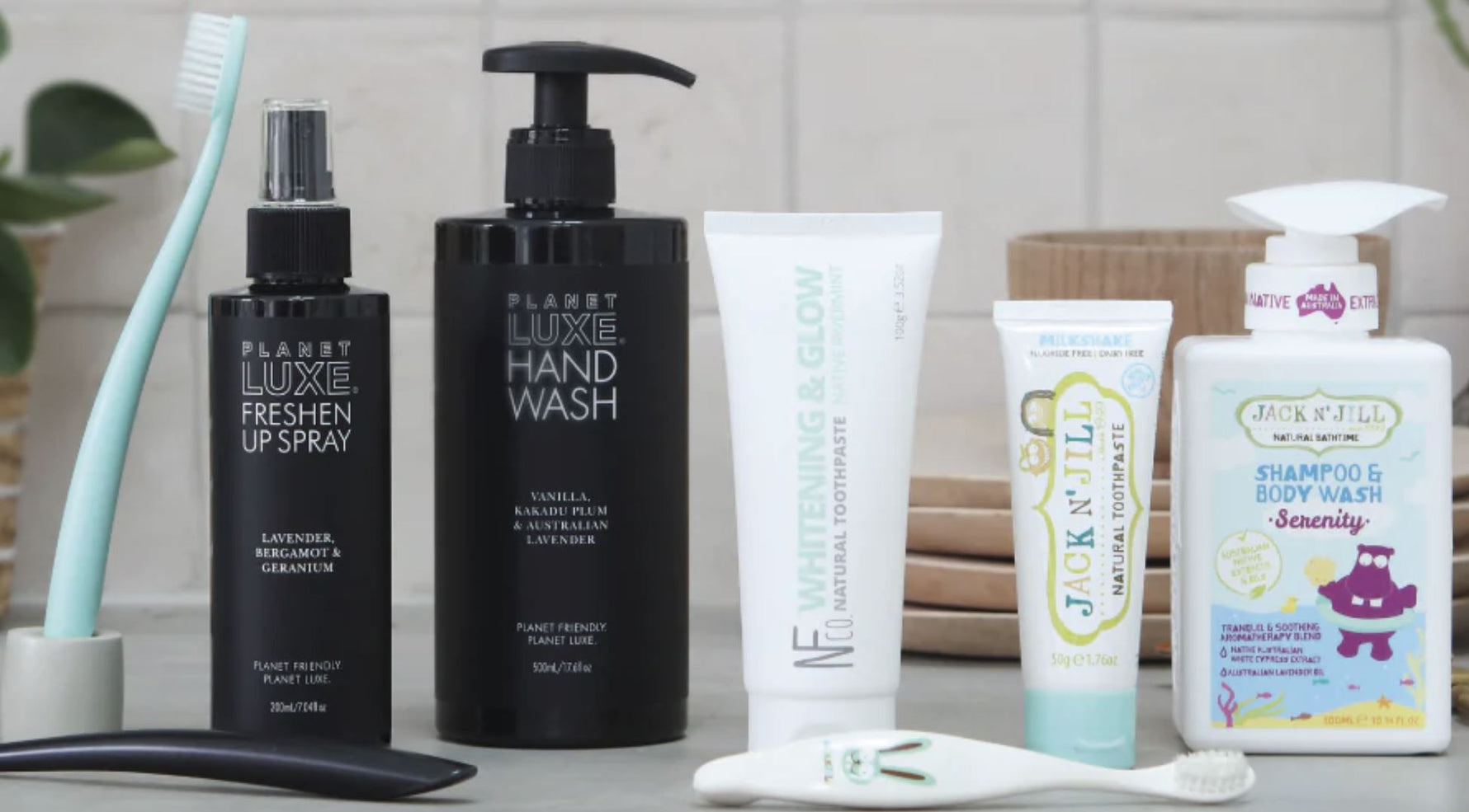 Collection of natural and organic personal care products on a bathroom counter.