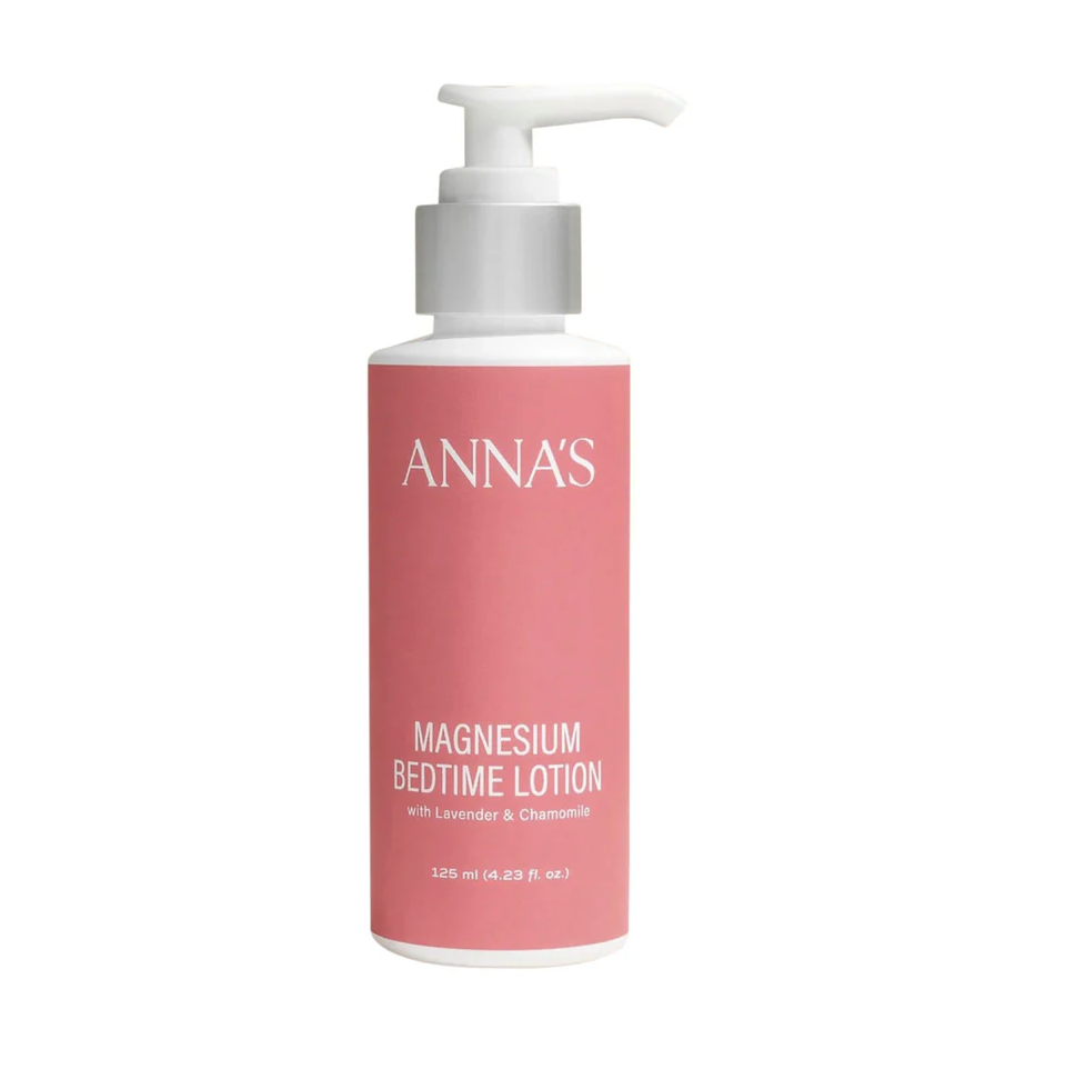 Pink bottle of Anna's Magnesium Bedtime Lotion with a white pump on a white background