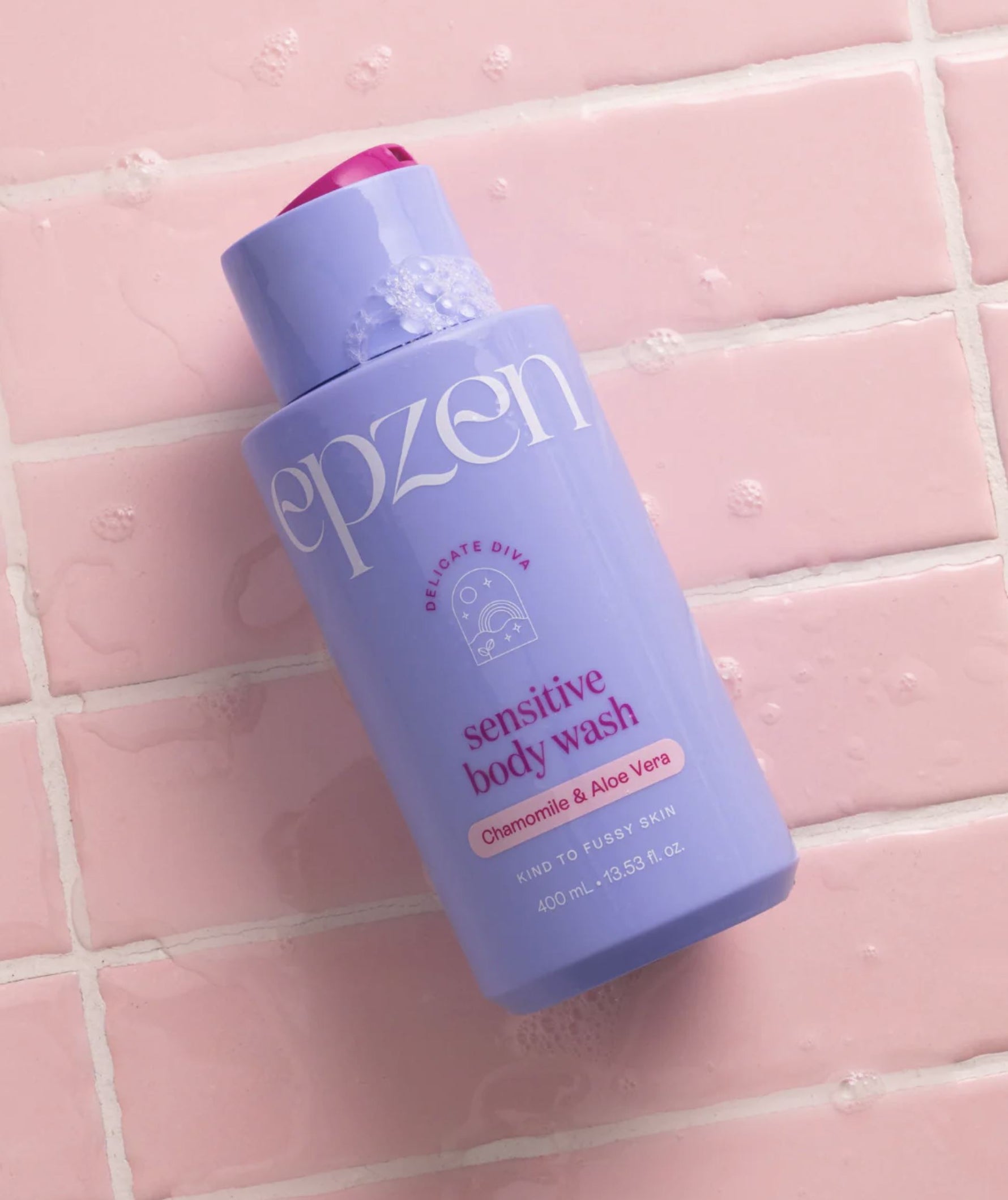 Purple bottle of epzen sensitive body wash on a pink tiled background