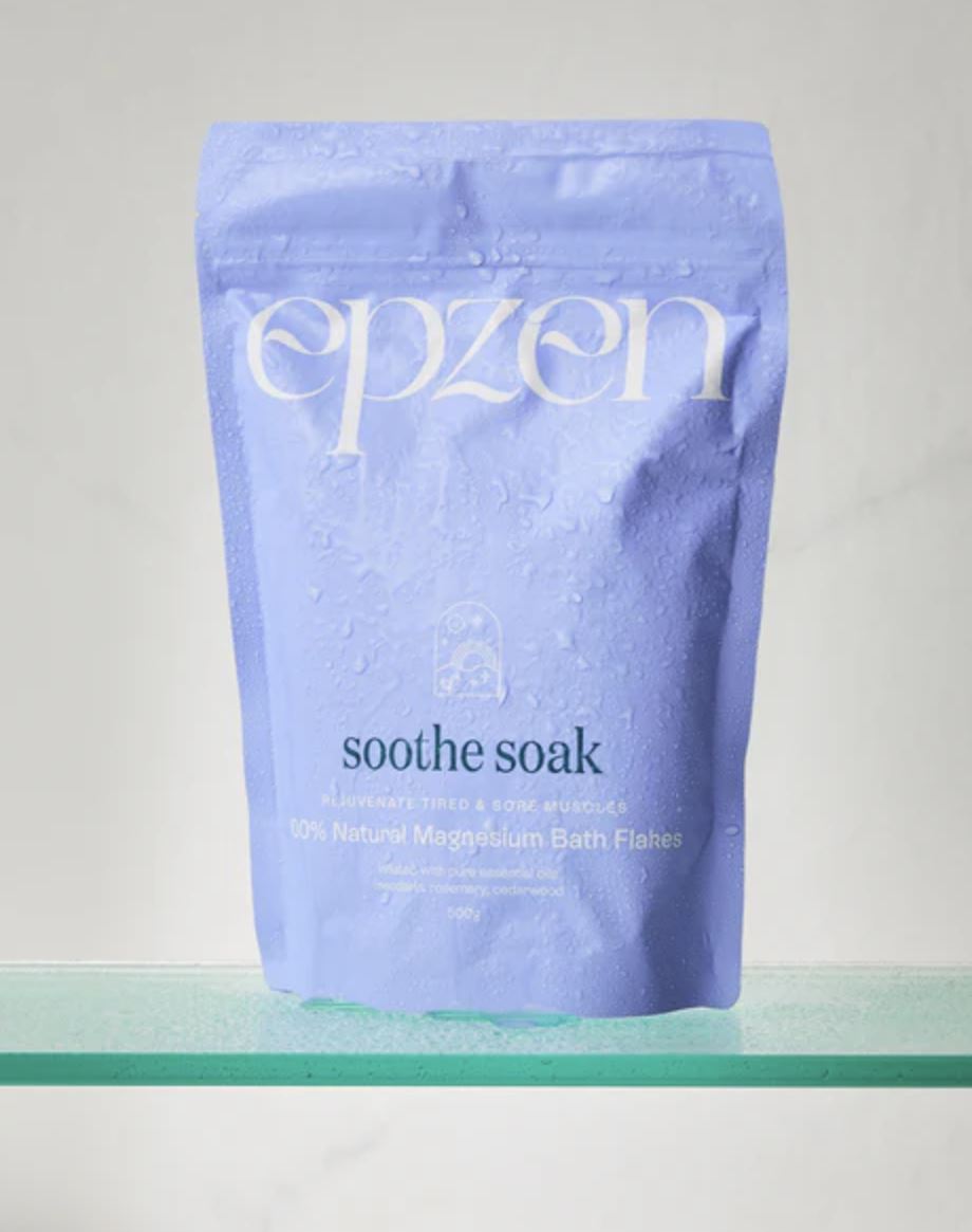 Purple package of 'epzen soothe soak' on a clear surface with a light gray background