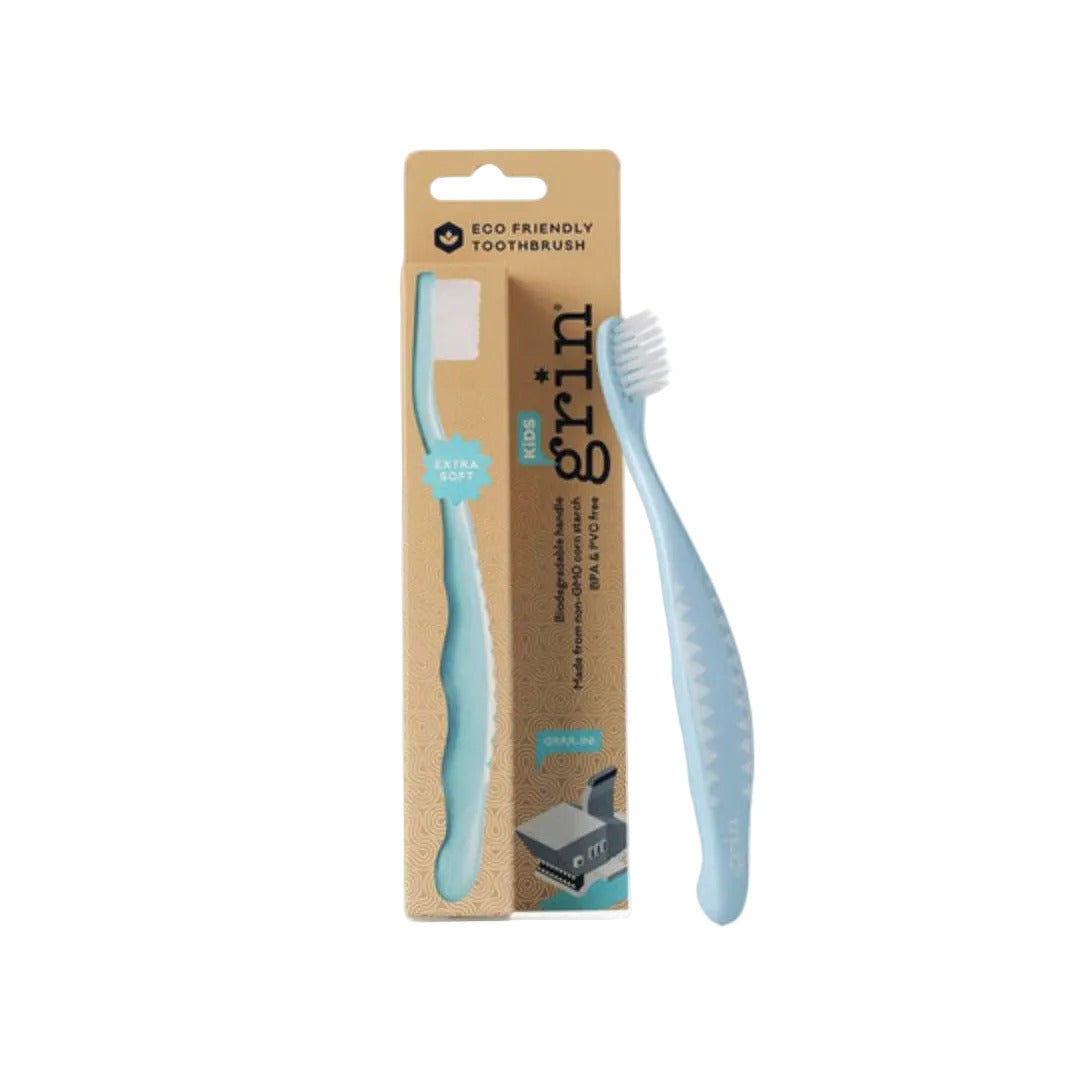 Light blue toothbrush with packaging labeled 'grin' on a white background