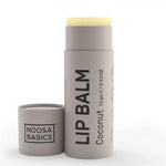 Lip balm stick with container on a white background, featuring 'Noosa Basics' branding.