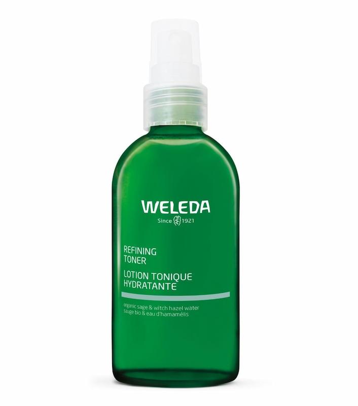 Green Weleda bottle with white cap on a white background