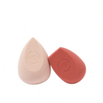 Two makeup sponges, one pink and one red, on a white background